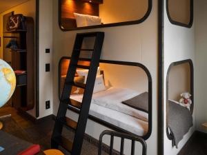 a room with two bunk beds and a mirror at 25hours Hotel Hamburg HafenCity in Hamburg