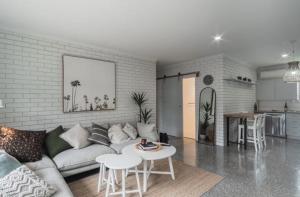 a living room with a couch and a table at Relax Inn in Mulwala