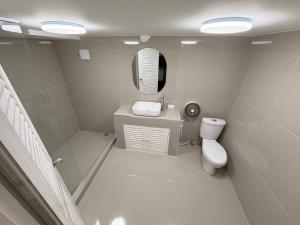 a bathroom with a toilet and a sink and a mirror at Moonlight Samui hotel and bar in Koh Samui  +43 photos