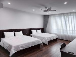 Ένα ή περισσότερα κρεβάτια σε δωμάτιο στο Hoàng Anh Hotel