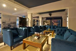 uma sala de estar com sofás azuis e uma mesa de centro em The Empyrean Airport Transit Hotel em Katunayaka