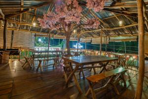 a dining room with tables and a tree in it at The Empyrean Airport Transit Hotel- 5 Mins from the Airport, Free Airport Pick or Drop, 24 Hr Front Desk in Katunayaka