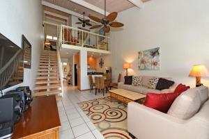 a living room with a couch and a ceiling fan at Kulakane 304 in Kahana