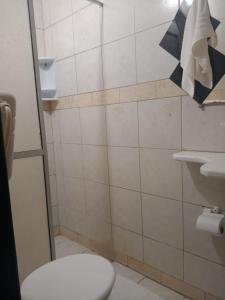 a bathroom with a toilet and a sink at pousada top mix apt103 in Florianópolis