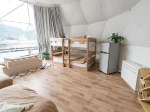 a bedroom with two bunk beds and a large window at Kaamlanai Harbor - Vacation STAY 48810v in Nichinan