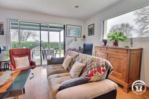 a living room with a couch and a table at Cerillac in Questembert