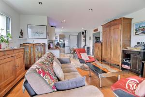 a living room with a couch and a fireplace at Cerillac in Questembert