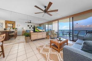 a living room with a couch and a table at Kahana Reef 201 · KR 201 OceanFront 1BD Condo w Ocean Views Pool in Kahana