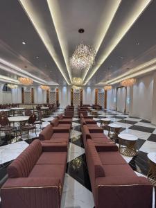 a restaurant with tables and chairs and a chandelier at B Dot in Gaushala