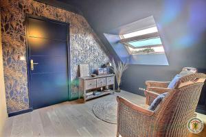 a room with a blue door and a window at La metairie in Plédèliac