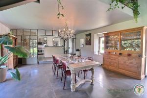 a dining room with a table and some chairs at La metairie in Plédèliac