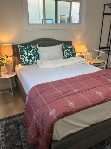 a large bed in a room with two tables at Flora in Ontario