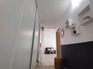 a hallway leading to a living room with a couch at Kampagn Jacuzzi - Rémire Wifi et climatisation in Bourda