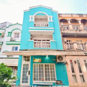 a blue building in front of some buildings at 芳心蘭厝民宿 in Wujie