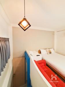 a small room with a bed and a couch at 芳心蘭厝民宿 in Wujie +5 photos