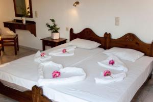 A bed or beds in a room at Anatoli Beach Hotel