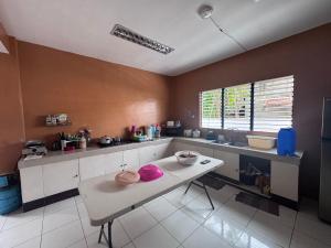 a kitchen with a table with two hats on it at V.P. GO INN in Solangon