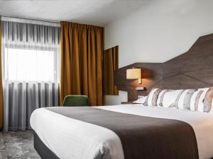 Postel nebo postele na pokoji v ubytování Mercure Belfort Centre