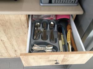 a drawer filled with utensils in a cabinet at 2 bedroom apartment in Atlit, Haifa district in Atlit