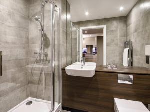 a bathroom with a sink and a shower at Aparthotel Adagio London Sutton Point in Sutton +89 photos