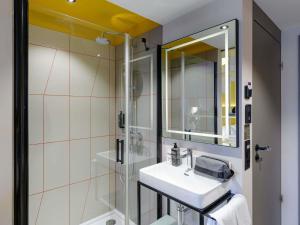 a bathroom with a sink and a shower at ibis Styles Zurich City Center in Zürich