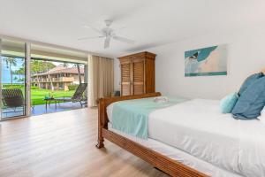 a bedroom with a bed and a balcony at Eldorado H107 · EL H107 Updated Kaanapali Condo w Beach Cabana G in Kahana +42 photos
