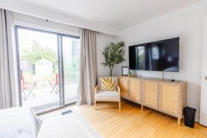 a bedroom with a flat screen tv on a dresser at Private 2-BR Suite w Patio in Mississauga