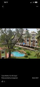 a picture of a building with a swimming pool at Candolim Sea Breez in Candolim