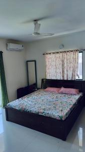 a bedroom with a large bed with a window at Candolim Sea Breez in Candolim +4 photos