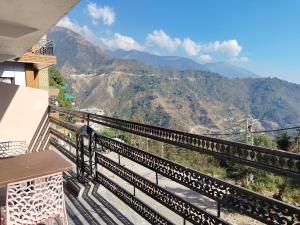 a balcony with a view of a mountain at Varuni Gd Hotel Mcleodganj in McLeod Ganj