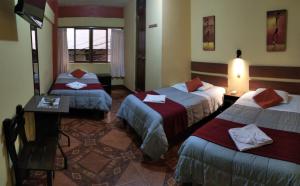 Ένα ή περισσότερα κρεβάτια σε δωμάτιο στο Hospedaje Tres Cruces