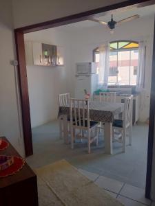 a kitchen and dining room with a table and chairs at pousada top mix apt 202 in Florianópolis