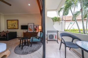a living room with a couch and a table and chairs at View Talay Longstay in Jomtien Beach