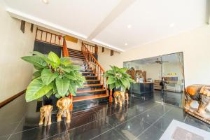 a lobby with a staircase and some plants at View Talay Longstay in Jomtien Beach