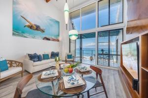a living room with a glass table and a couch at Napili Point C3 · NP C3 Renovated OceanFront to Whale Watch Rela in Kahana