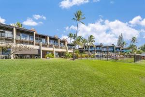 a large building with a lawn in front of it at Napili Point C3 · NP C3 Renovated OceanFront to Whale Watch Rela in Kahana