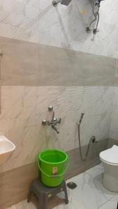 a bathroom with a bucket and a toilet and a shower at Shreeramyadham vrindavan in Vrindāvan
