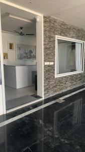 a living room with a tv on a brick wall at Shreeramyadham vrindavan in Vrindāvan