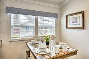 a dining room table with dishes on it with a window at Dosanko Cottage & Fjord Suite at Equestrian House PA in Pleasant Mount