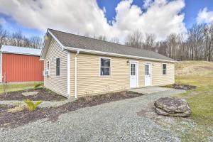 a small house with a red building in a field at Clydesdale Cottage & Brandenburger Suite at Equestrian House PA in Pleasant Mount