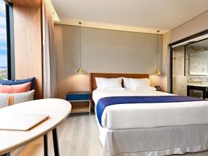 Postel nebo postele na pokoji v ubytování Novotel Santa Cruz De La Sierra