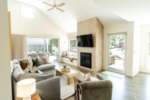 a living room with two couches and a fireplace at Amber Mist Villa - Two in Bright