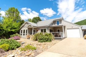 a house with a garage and a driveway at Amber Mist Villa - Two in Bright