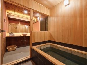 a bathroom with a tub with a sink at 宿 -Shuku- in Inuyama +23 photos