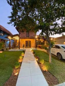 a house with a car parked in front of it at Kasa util in Gravatá
