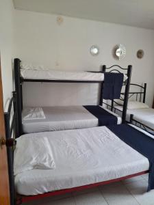 En eller flere senge i et værelse på BBB Apartamento en Edificio Mixto