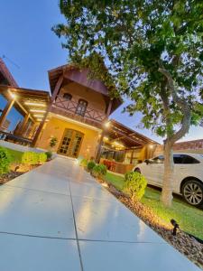 a house with a car parked in front of it at Kasa util in Gravatá