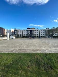 an empty parking lot in front of a building at Cozy 3br apartment near to airport & beaches in La Cana +19 photos