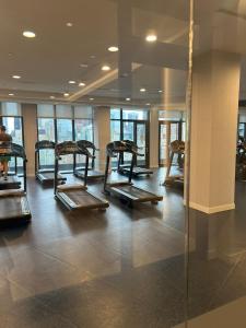 a gym with a row of exercise equipment in a building at Downtown Luxury Condo Gym & Parking in Toronto