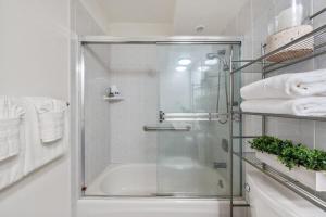 a shower with a glass door in a bathroom at Milowai 302 · MIL 302 Oceanfront 2BD w Ocean Views Whale Watch in Wailuku +50 photos